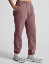 pink sweatpants with pockets and a drawstring at waistband.
